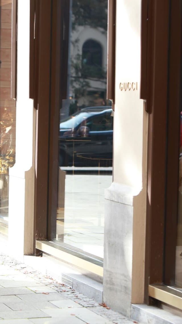 Zwei elegant gekleidete Frauen betrachten bewundernd ein Schaufenster in einer Münchner Einkaufspassage.