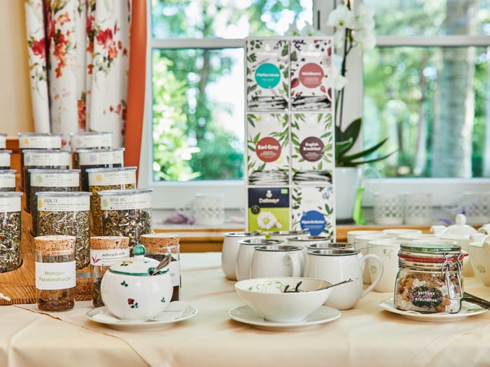 Tea station with loose-leaf tea selection and accessories.